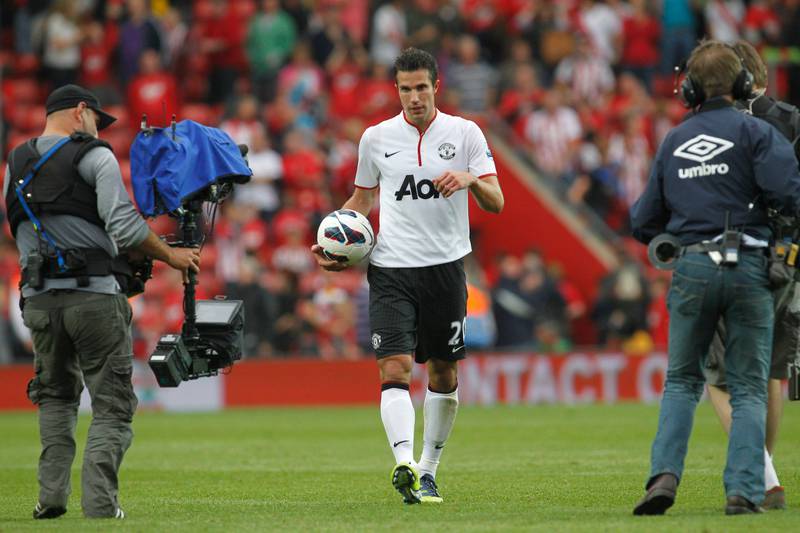 Manchester United's Robin Van Persie, center, collects the match ball after scoring his hat-trick goal against Southampton at the end of their English Premier League soccer match at St Mary's stadium, Southampton, England, Sunday, Sept. 2, 2012. (AP Photo/Sang Tan) *** Local Caption ***  Britain Soccer Premier League.JPEG-09952.jpg