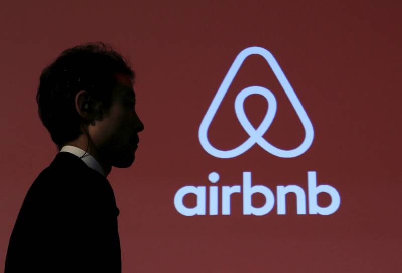 FILE PHOTO: A man walks past a logo of Airbnb after a news conference in Tokyo, Japan, November 26, 2015. REUTERS/Yuya Shino/File Photo