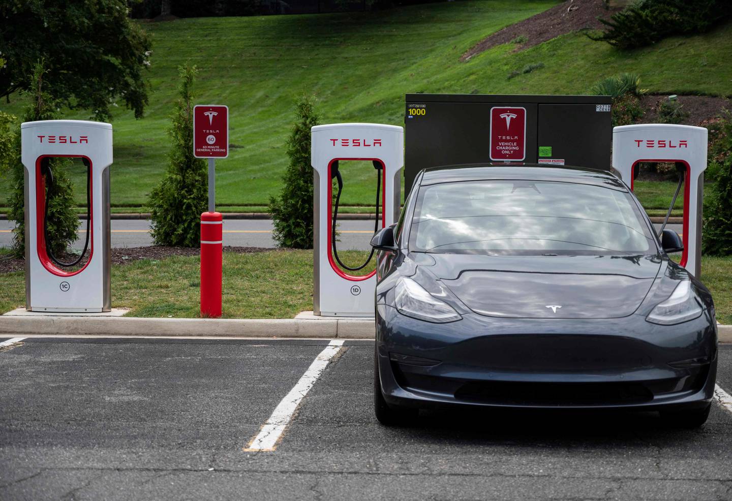 Cars charge at a Tesla super charging station in Arlington, Virginia.  Second-quarter deliveries more than doubled year on year to 201,304. Photo: AFP