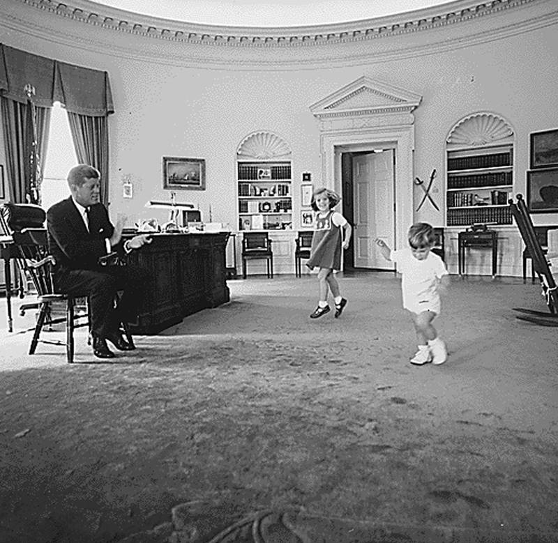 US president John F Kennedy with his children Caroline Kennedy and John F Kennedy Jr in the Oval Office on October 10, 1962. AFP 