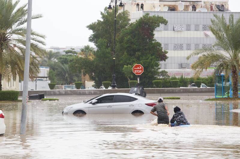 Young people use an inflatable in floodwaters, in the Gubrah area of Muscat, Oman. Tara Atkinson for The National
