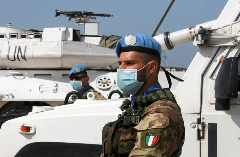 A UN peacekeeper wears a mask as he stands near UN vehicles in south Lebanon’s Naqoura city near the Lebanese-Israeli border. Reuters