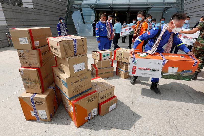 A Chinese official carries medical supplies to a truck after a handover ceremony at the Council of Ministers in Phnom Penh, Cambodia. China donated medical supplies to Cambodia to prevent the spread of coronavirus. EPA
