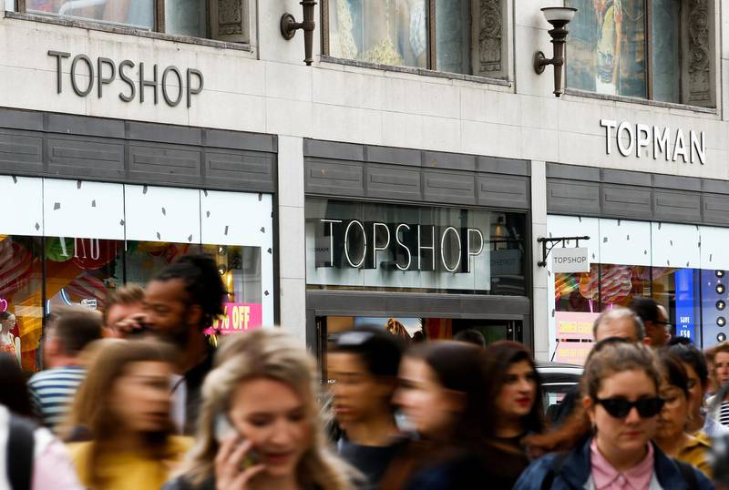 FILE PHOTO: People walk past a Topshop and Topman store, owned by Arcadia Group, in central London, Britain, June 5, 2019. REUTERS/Henry Nicholls/File Photo