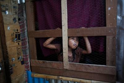 A Rohingya girl looks out of a window. Niranjan Shrestha / AP Photo