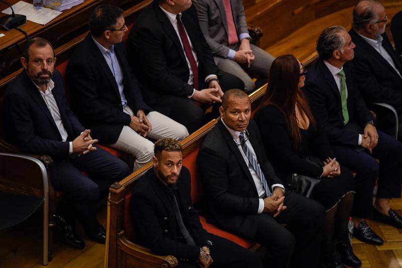 Paris Saint-Germain's Neymar Junior, front, with his father Neymar Senior, to his left, former Barcelona president Sandro Rosell, left and ex-Barca president Josep Maria Bartomeu, second left, at the first day of a trial over alleged irregularities in his transfer to the Catalans nearly a decade ago. AFP