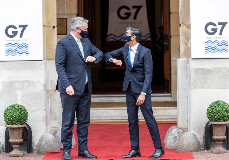 Britain's Chancellor of the Exchequer Rishi Sunak (R) welcomes Secretary-General of the Organisation for Economic Co-operation and Development (OECD) Matthias Corman to the G7 Finance Ministers Meeting at Lancaster House, central London on June 4, 2021.
 Group of Seven (G7) finance chiefs gather this week to hammer out an agreement on corporate tax harmonisation aimed at raising revenues as economies recover from the coronavirus pandemic. / AFP / POOL / Steve REIGATE
