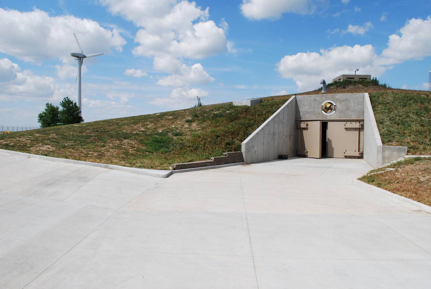 The entrance to the existing luxury bunker, with its wind turbine on the left. Courtesy: Survival Condo Project