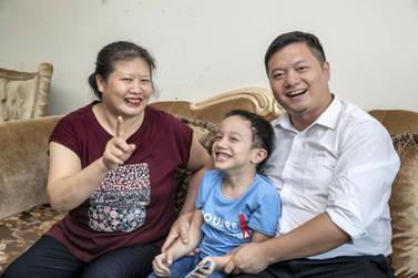 Can Cai, a Chinese resident, and his mother, Ying Luo, and five-year-old son, Tiancheng Cai. Antonie Robertson / The National