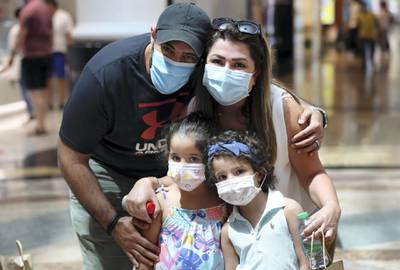 Dubai, United Arab Emirates - Reporter: Kelly Clarke. Coronavirus/Covid-19. Farah Altaher (mum), Ghaith Ghnimat (dad), Ghazal Ghnimat (L) and Yara Ghnimat. Parents rush to buy PPE for children in time for back-to-school. Sunday, August 23rd, 2020. Dubai. Chris Whiteoak / The National