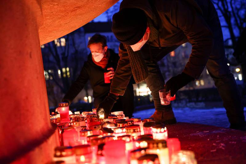 People light candles during a vigil to commemorate the people who died due to the coronavirus disease, in Berlin, Germany. Reuters