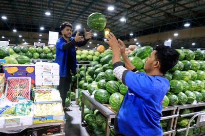 Workers arrange fruit at a fresh produce market in Dubai before the Muslim fasting month. AFP