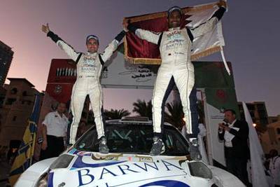 Nasser Saleh Al Attiyah, right, with co-driver Giovanni Bernacchini of Italy, overcame several problems, including striking a tree and tyre punctures, to win the Dubai International Rally and ensure Al Attiyah of a seventh Middle East Rally Championship title