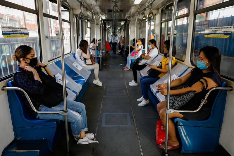 Passengers sit in between social distancing markers on the first day of train operations since the lockdown.  Reuters