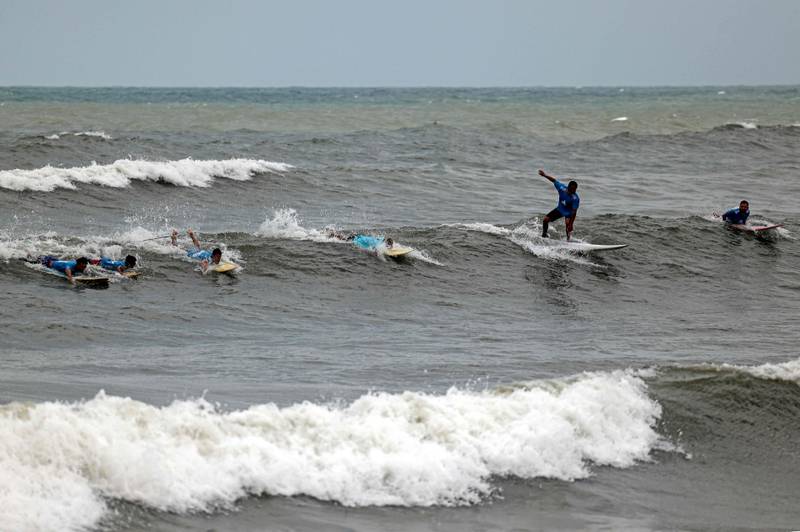 Palestinian surfers rides a wave in Gaza City.
