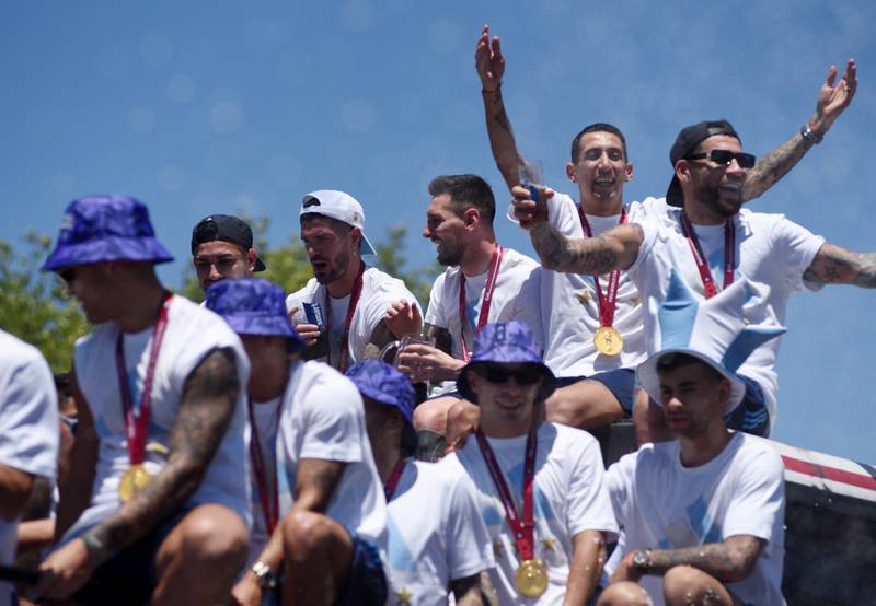 Lionel Messi, Rodrigo De Paul, Leandro Paredes, Angel Di Maria and teammates celebrate on the bus. Reuters