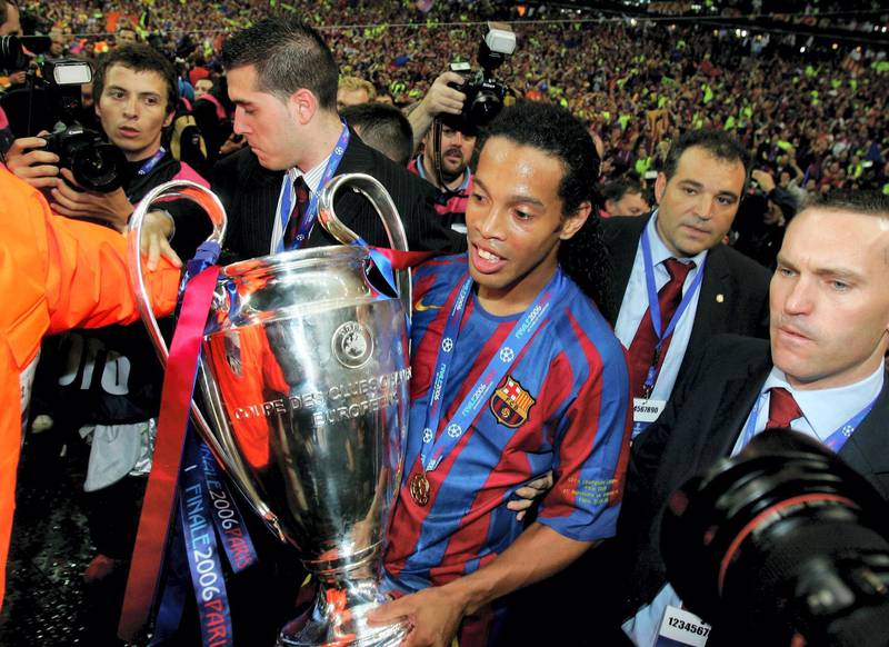 PARIS - MAY 17:  Ronaldinho of Barcelona carries the trophy in celebration after his team wins the UEFA Champions League Final between Arsenal and Barcelona at the Stade de France on May 17, 2006 in Paris, France.  (Photo by Alex Livesey/Getty Images)