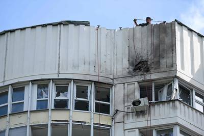 The damaged facade of a multi-storey apartment building after a drone attack in Moscow. AFP