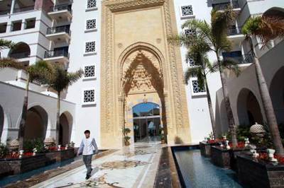 An employee is seen at the entrance to the Jumeirah Zabeel Saraya hotel, which opened on Dec. 27 and is operated by the Jumeirah Group LLC, is seen in Dubai, United Arab Emirates, on Monday, Jan. 24, 2011. Jumeirah Group LLC, the hotel-management company that operates Dubai's sail-shaped Burj Al Arab, may open at least six other locations around the world this year, Executive Chairman Gerald Lawless said. Photographer: Gabriela Maj/Bloomberg *** Local Caption ***  793954.jpg
