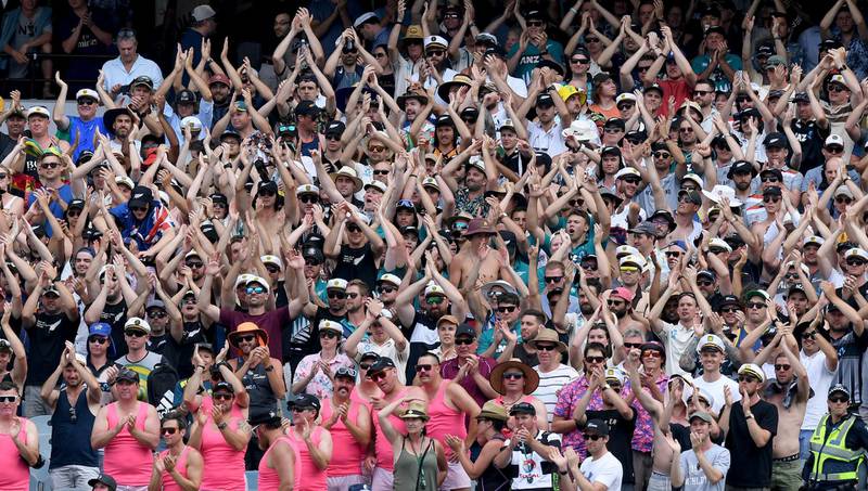 New Zealand fans cheer off their team as players leave the field after play at their cricket test match against Australia in Melbourne, Australia, Saturday, Dec. 28, 2019. (AP Photo/Andy Brownbill)