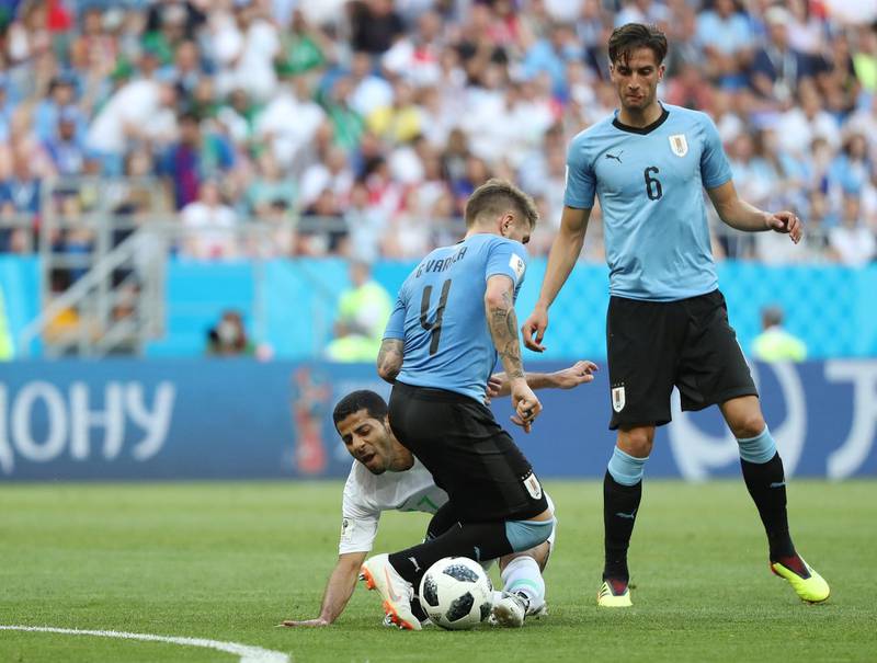 Uruguay's Guillermo Varela and Rodrigo Bentancur in action with Saudi Arabia's Taisir Al-Jassim. Marko Djurica / Reuters