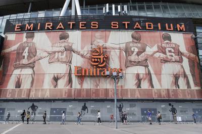 People queue at a vaccination centre at Arsenal's Emirates Stadium, in London.