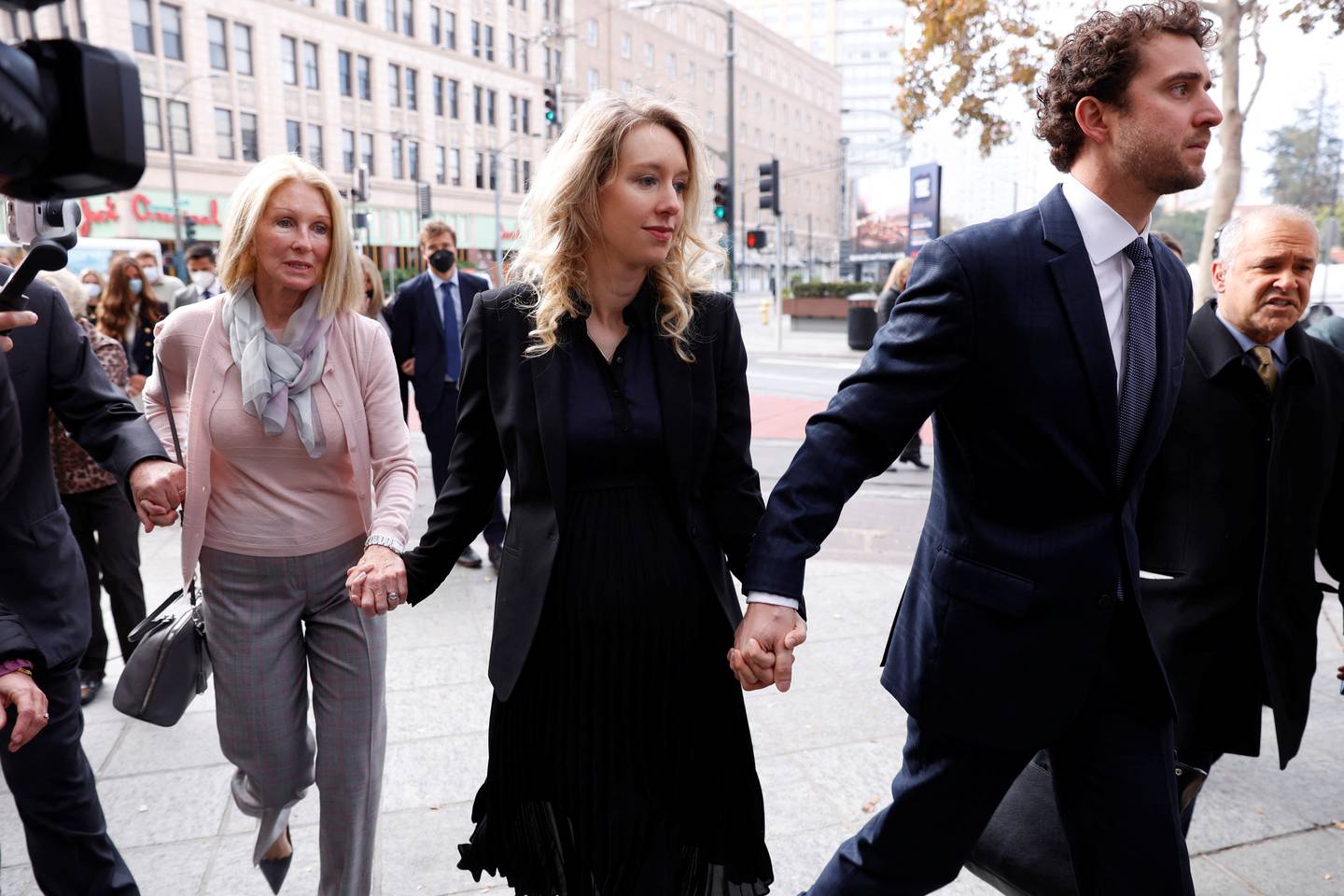 Theranos founder Elizabeth Holmes arrives with her family and partner Billy Evans to be sentenced on her convictions for defrauding investors. Reuters