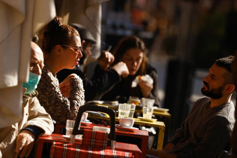 People sit at a cafe after the coronavirus disease restrictions were eased in Rome. Reuters