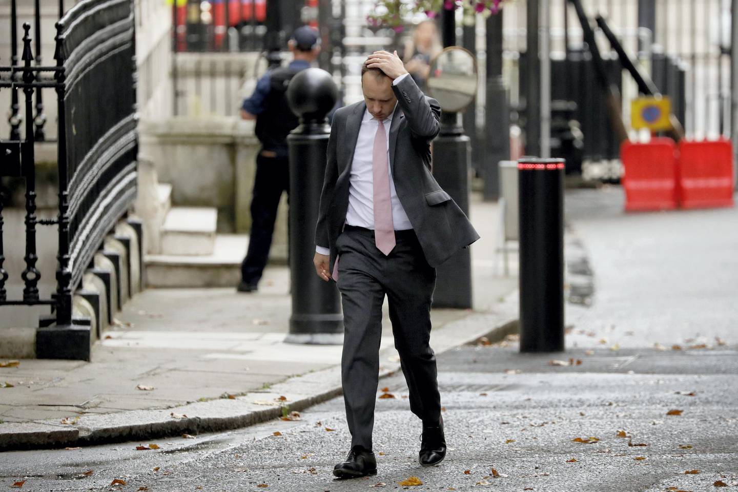 FILE - In this Wednesday, Sept. 23, 2020 file photo British Health Secretary Matt Hancock walks through Downing Street on his way into number 10, in London. More than 100,000 people have died in the United Kingdom after contracting the coronavirus. That's according to government figures released Tuesday Jan. 26, 2021. Britain is the fifth country in the world to pass that mark, after the United States, Brazil, India and Mexico, and by far the smallest. The U.S. has recorded more than 400,000 COVID-19 deaths, the world's highest total, but its population of about 330 million is about five times Britain's. (AP Photo/Matt Dunham, File)