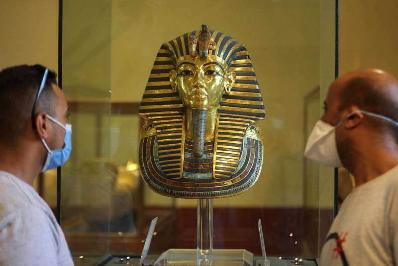 Tourists look at the golden mask of ancient pharaoh king Tutankhamen as they visit the Egyptian Museum at Tahrir Square. Reuters