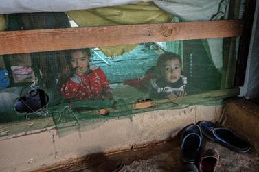 Syrian refugee children seen inside a tent in a camp in Mohammara, Lebanon. EPA