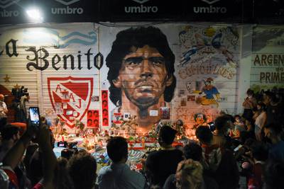 People gather to mourn the death of soccer legend Maradona, outside the Diego Armando Maradona stadium, in Buenos Aires. Reuters