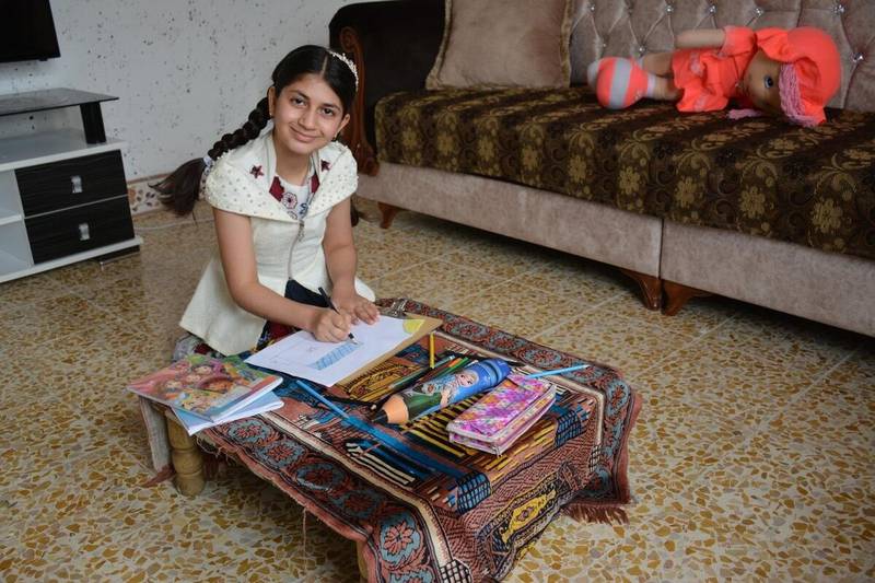 Raya has learnt to read and write at a centre run by Save the Children in Iraq. Photo: Save the Children