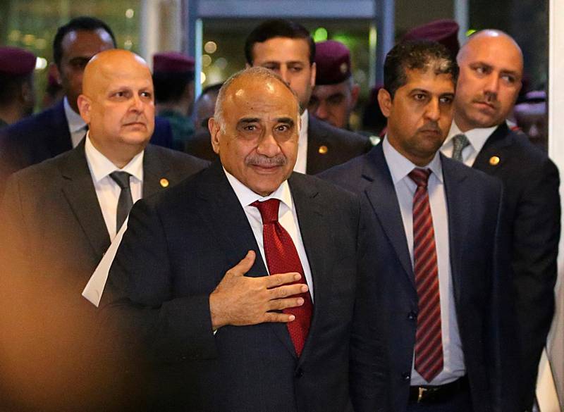 FILE - In this Oct. 24, 2018 file photo, then Prime Minister-designate Adel Abdul-Mahdi, center, arrives to the parliament building, in the heavily guarded Green Zone, in Baghdad, Iraq. Abdul-Mahdi told reporters at a press conference on Monday, Dec. 24, 2018, that his government could deploy troops inside Syria, in the latest fallout from the U.S. decision to withdraw from the war-torn country. The prime minister said his government is "considering all the options" to protect Iraq from threats across its borders. (AP Photo/Hadi Mizban, File)