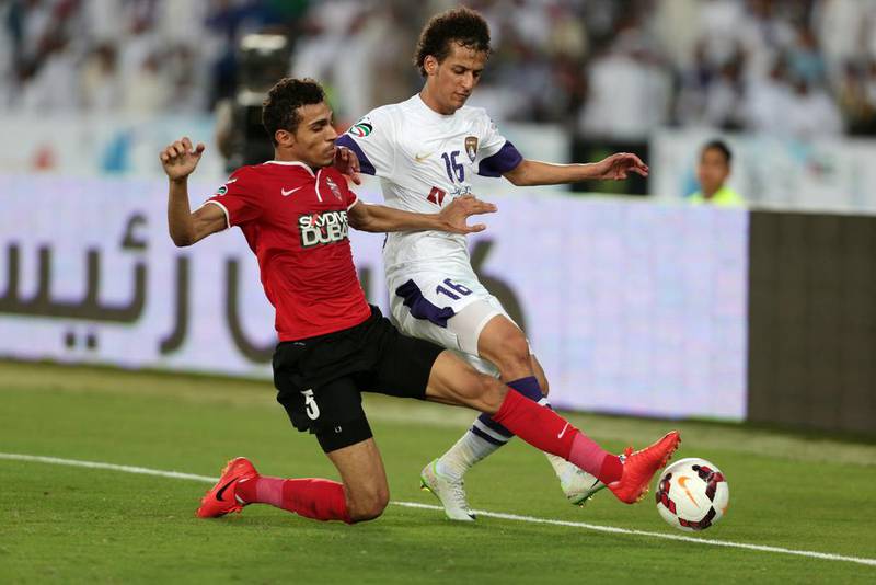 Saad Suroor of Al Ahli, left,  and Mohamed Abdulrahman of Al Ain, right, battle for the ball during the President's Cup final. Christopher Pike / The National / May 18, 2014