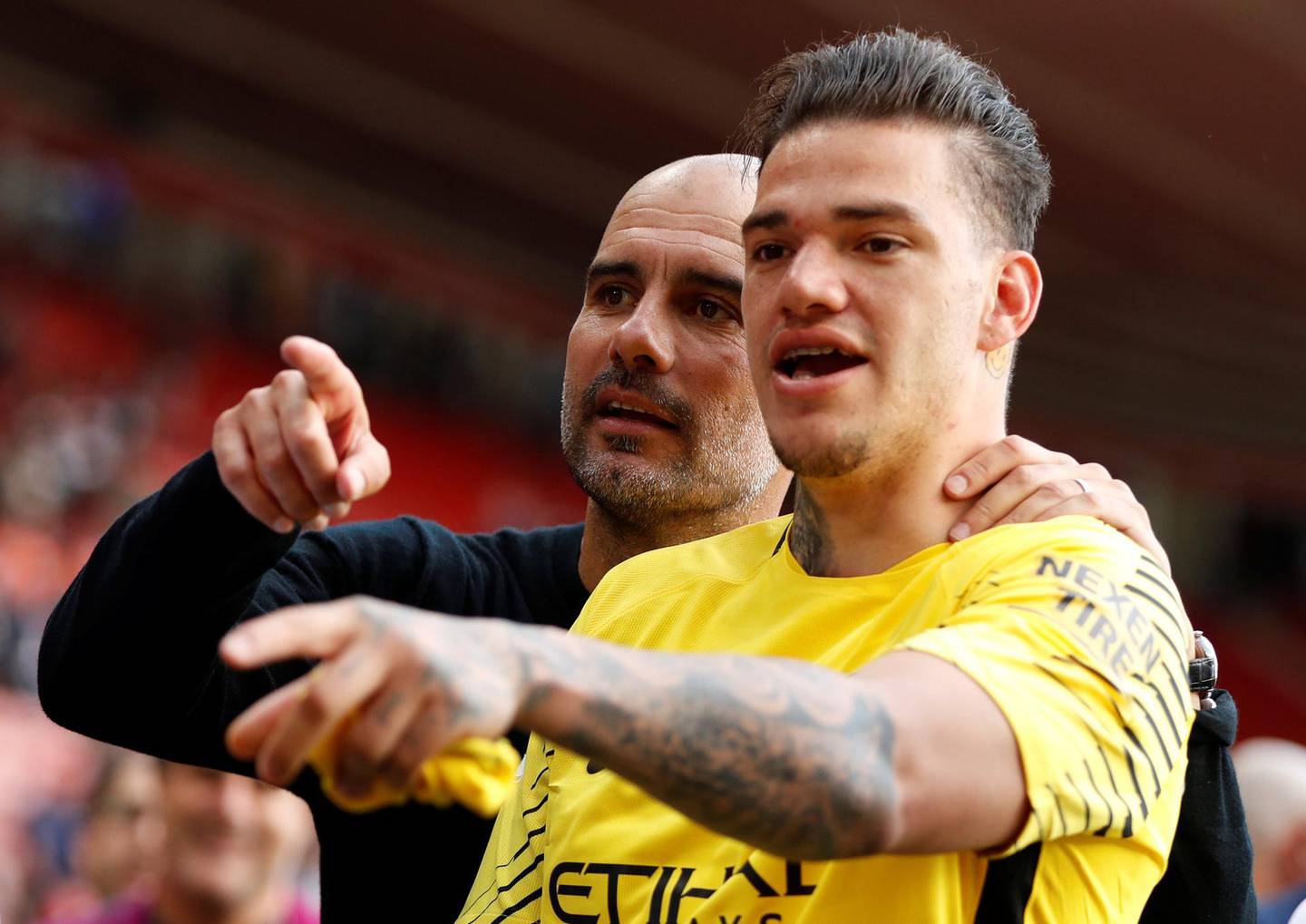 Soccer Football - Premier League - Southampton vs Manchester City - St Mary's Stadium, Southampton, Britain - May 13, 2018   Manchester City manager Pep Guardiola celebrates with Ederson after the match   Action Images via Reuters/John Sibley    EDITORIAL USE ONLY. No use with unauthorized audio, video, data, fixture lists, club/league logos or "live" services. Online in-match use limited to 75 images, no video emulation. No use in betting, games or single club/league/player publications.  Please contact your account representative for further details.
