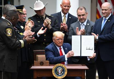 US President Donald Trump shows his signature on an Executive Order on Safe Policing for Safe Communities, in the Rose Garden of the White House in Washington, DC.  AFP