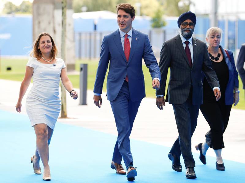 Canada's prime minister Justin Trudeau arrives with foreign minister Chrystia Freeland and defence minister Harjit Sajjan. Reuters