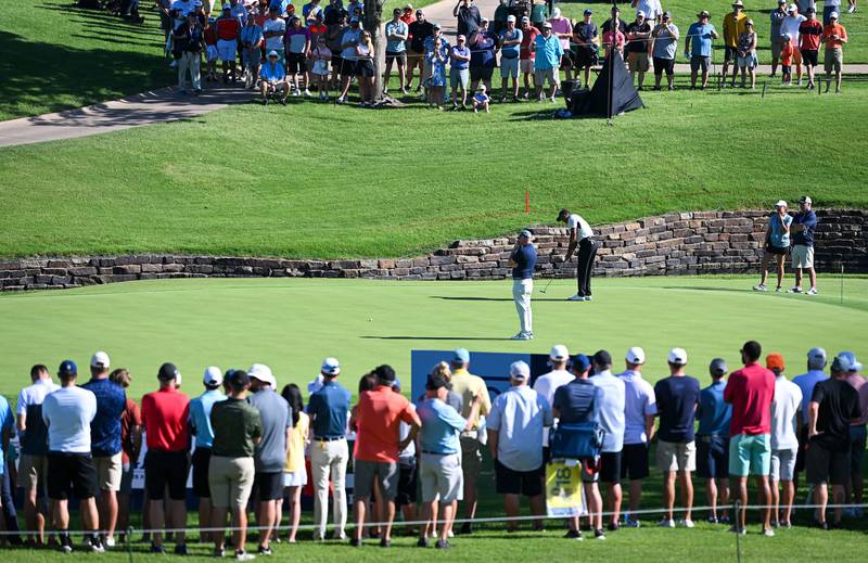 Fans watch Tiger Woods putt on the 11th green during a practice round ahead of the 2022 PGA Championship. Getty
