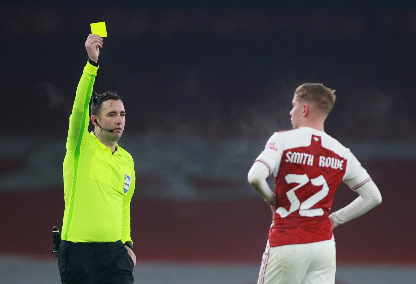 Soccer Football - FA Cup - Third Round - Arsenal v Newcastle United - Emirates Stadium, London, Britain - January 9, 2021 Arsenal's Emile Smith Rowe is shown a yellow card by referee Chris Kavanagh after a red card was overturned following a VAR review REUTERS/Hannah Mckay