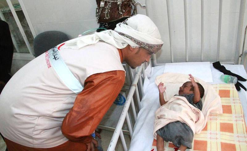 An Emirates Red Crescent worker with a tiny patient in Pakistan. The UAE charity is ready to start rebuilding the country’s crisis-hit health system. Wam