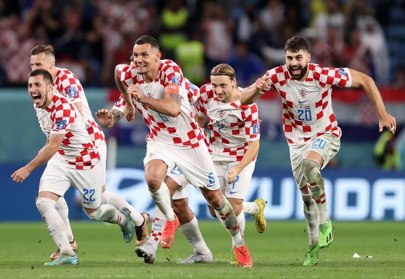 Croatia players celebrate after beating Japan on penalties in their World Cup last-16 match at Al Janoub Stadium on December 5, 2022. Getty