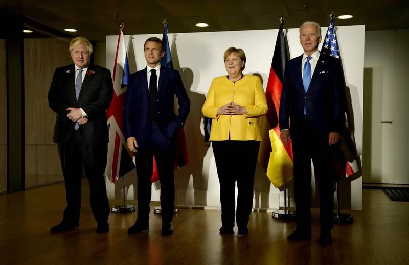 From right to left, US President Joe Biden, Ms Merkel, French President Emmanuel Macron and British Prime Minister Boris Johnson pose before a meeting on the sidelines of the G20 summit in Rome, in October 2021. AP