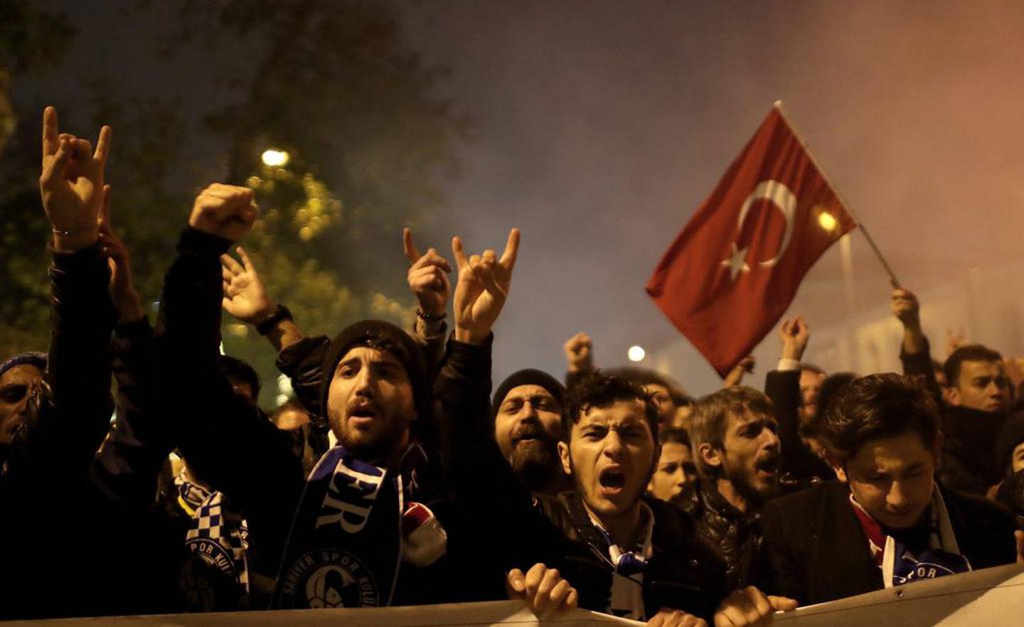 Turkish football fans shout slogans as they protest against twin bombings two days before, near the scene of one of the explosions outside the Besiktas Vodafone arena on December 10, 2016. EPA