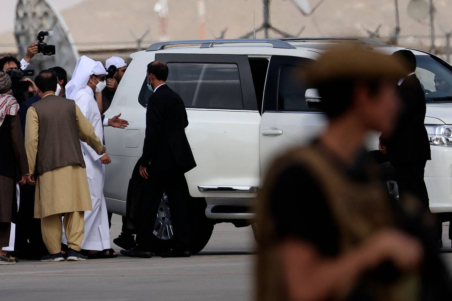 Qatari Foreign Minister Mohammed bin Abdulrahman Al Thani (centre) gets into a car after landing in Kabul. AFP