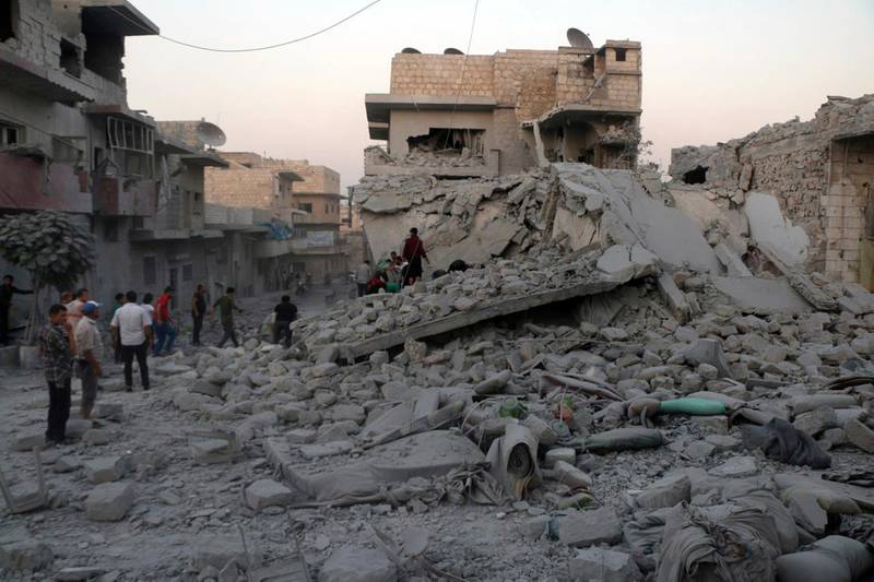 This photo released Wednesday, Aug. 28, 2019 by the opposition Syrian Civil Defense rescue group, also known as White Helmets, which has been authenticated based on its contents and other AP reporting, shows people searching for victims under the rubble of destroyed buildings that was hit by airstrikes in the northern town of Maaret al-Numan, in Idlib province, Syria. Idlib is the Syrian opposition's final stronghold. The opposition Syrian Civil Defense group of first responders said airstrikes on Maaret al-Numan on Wednesday killed 12 people and wounded 34. (Syrian Civil Defense White Helmets via AP)