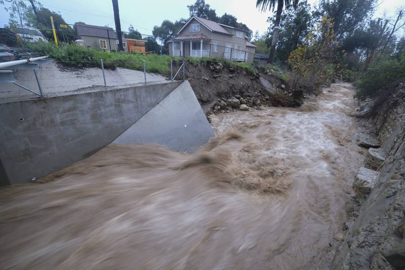 Water rages along Montecito Creek in Montecito on Tuesday. AP