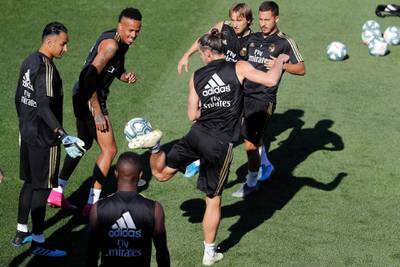 Gareth Bale, centre, controls the ball next to his teammates. EPA