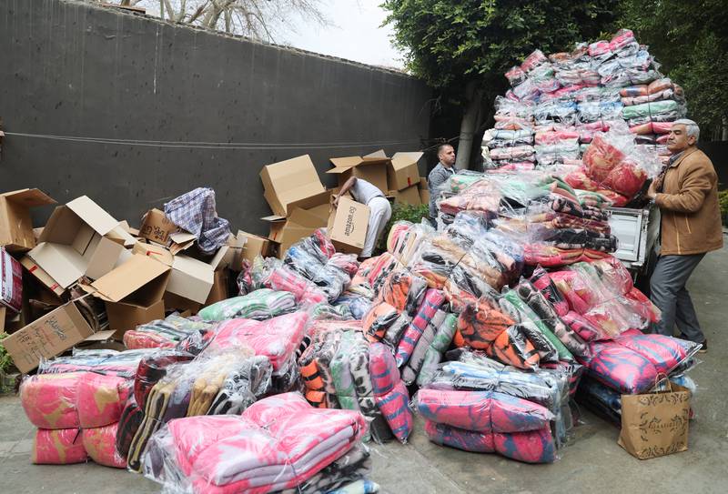 Men in Cairo prepare blankets and clothes to be donated to people in Turkey. Reuters