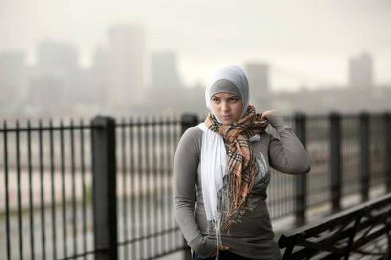 This woman is Danya Ghatih, 20, and a Muslim, was ten years-old at the time of the 911 attacks.  Danya lives and works in Brooklyn New York, pictured here on the Brooklyn Promenade over looking NYC.
Photo by Michael Falco